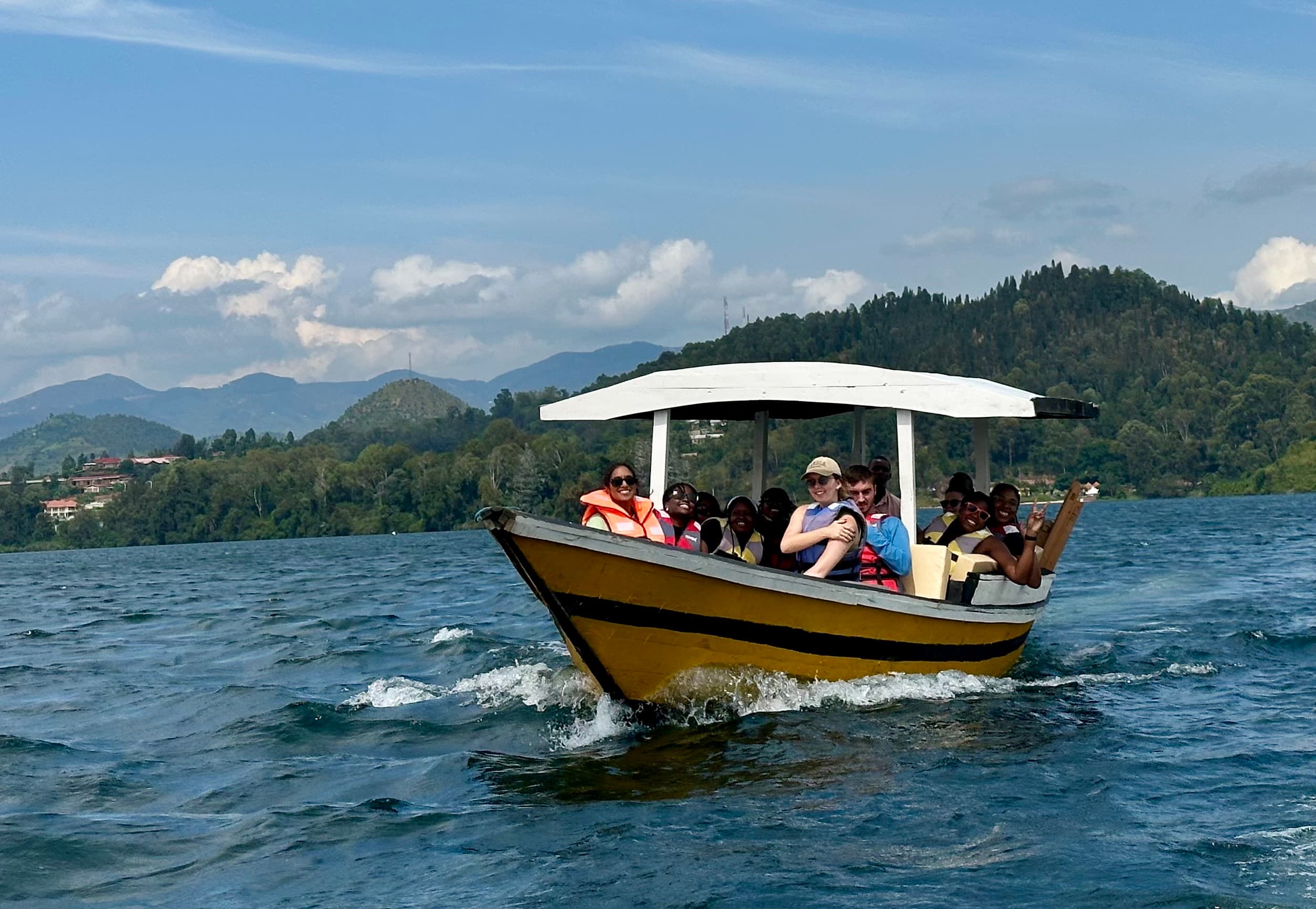 Visitors heading to the paradise islands of Lake Kivu within our locally made wooden boat